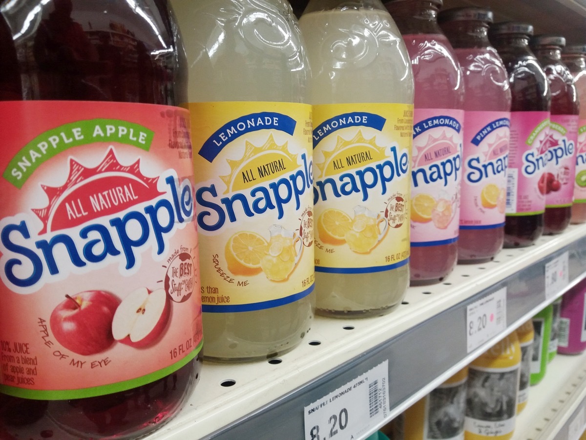 snapple drink bottles on grocery store shelf, original brand names