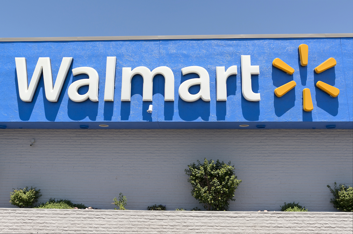 Close up of the Walmart logo on a storefront on a sunny day