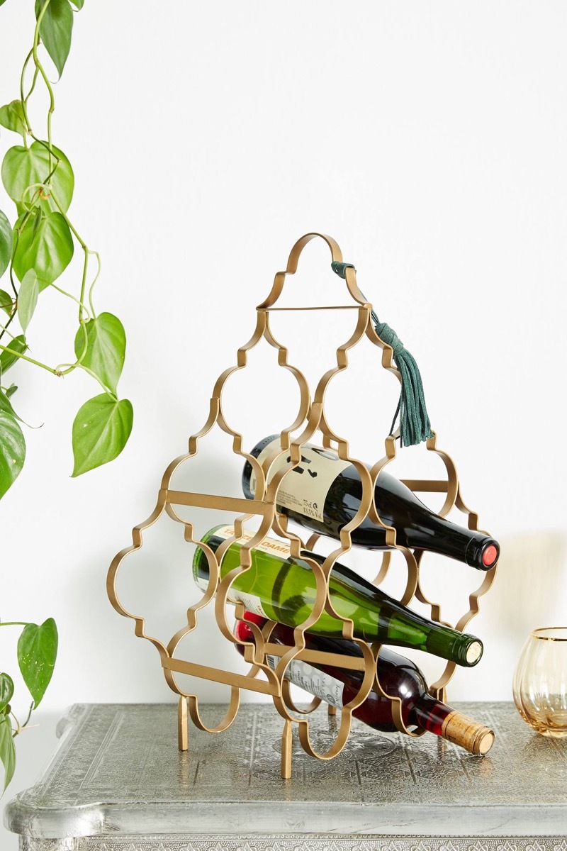 bottles of wine in a gold rack, kitchen decorations