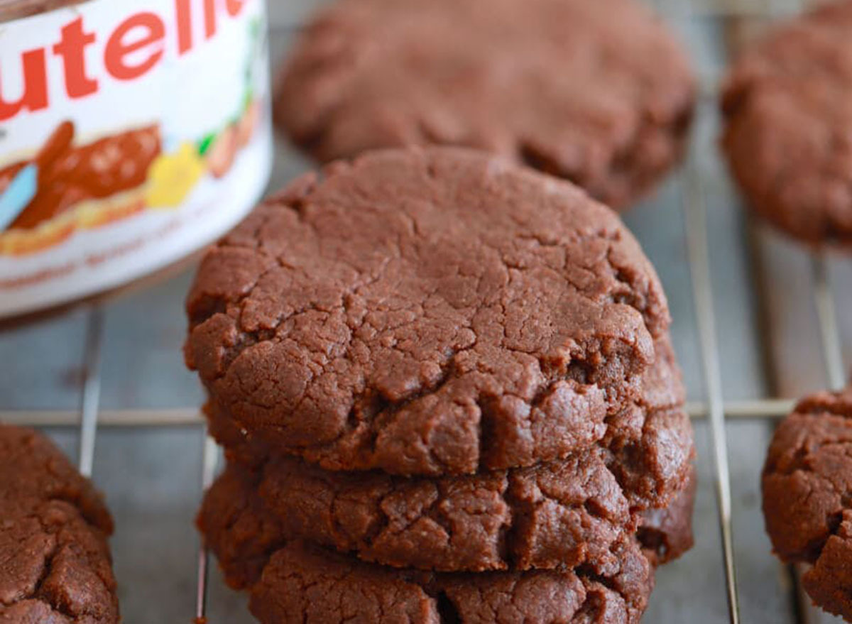 Nutella cookies on a cooling rack with jar of Nutella
