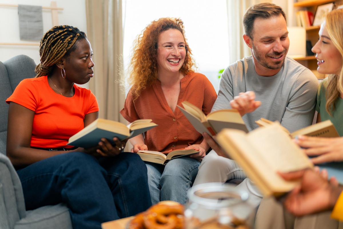 Group of women and men attending a book club meeting