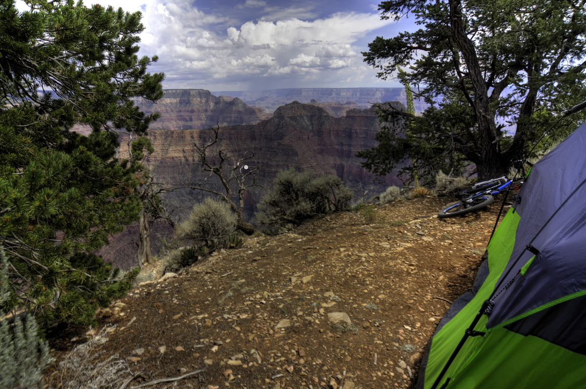 A camper is set up on the North Rim of the Grand Canyon
