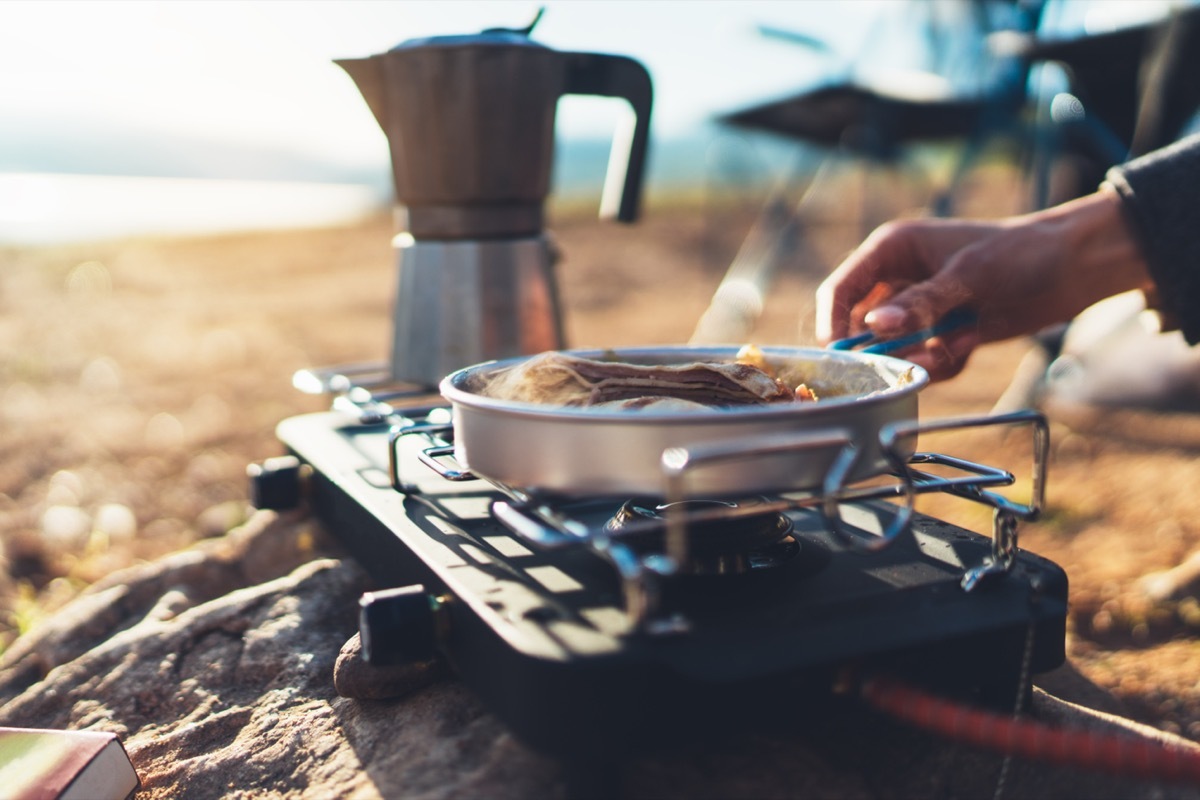 moka pot coffee campsite morning lifestyle, person cooking hot drink in nature camping outdoor