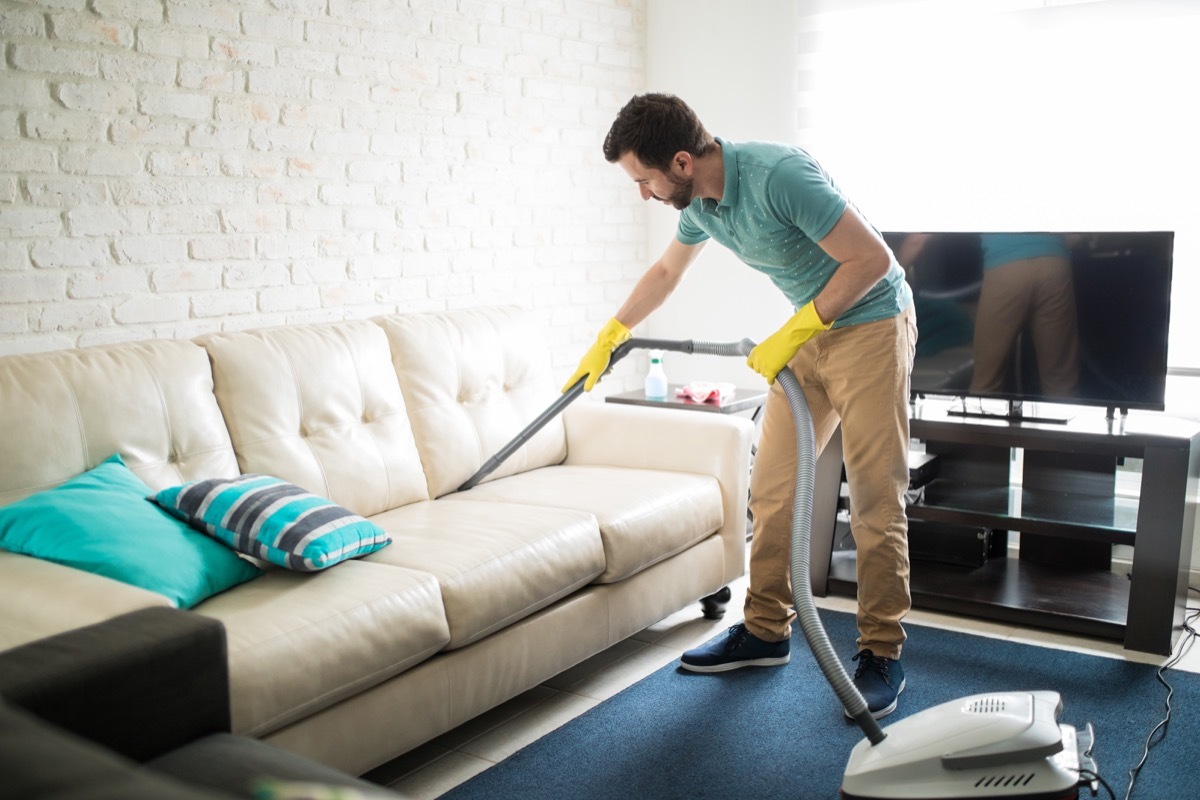 Man cleaning living room