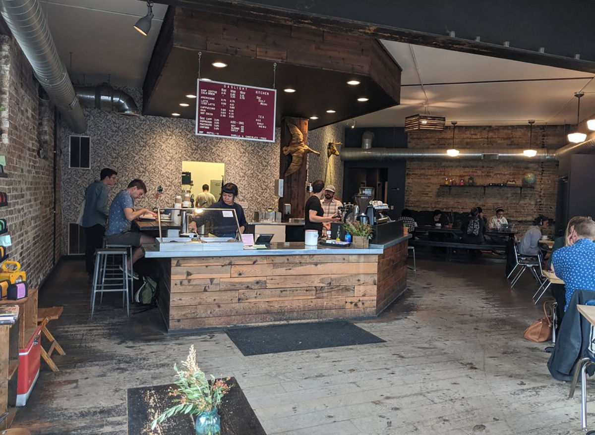 interior of gaslight coffee roasters in chicago with baristas and tables and seats