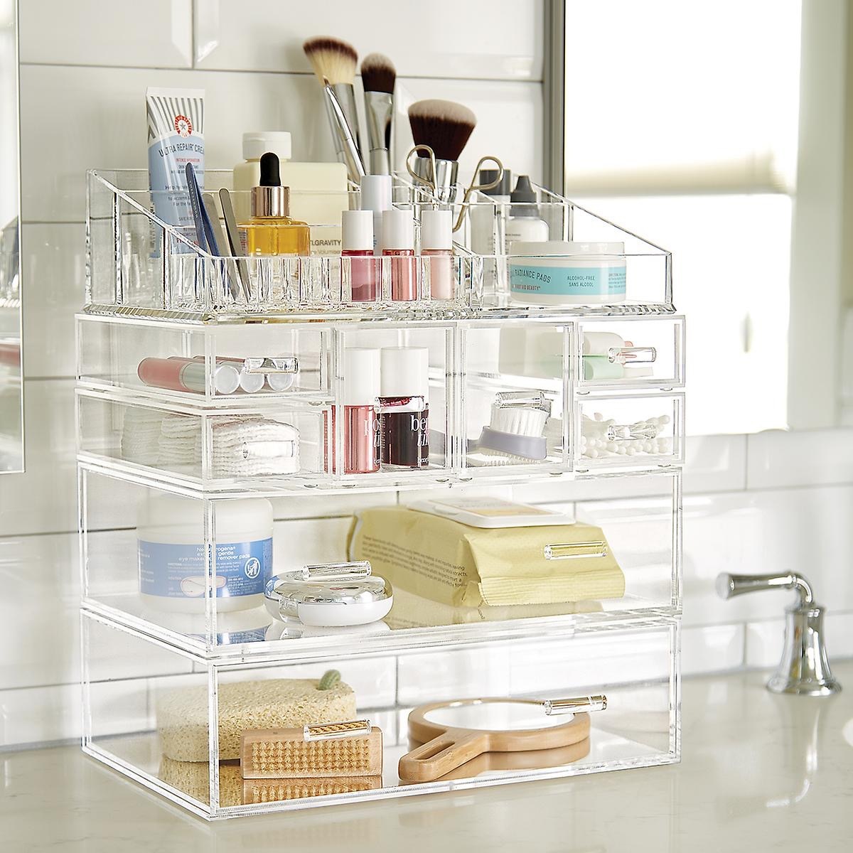 Clear acrylic case with makeup on counter