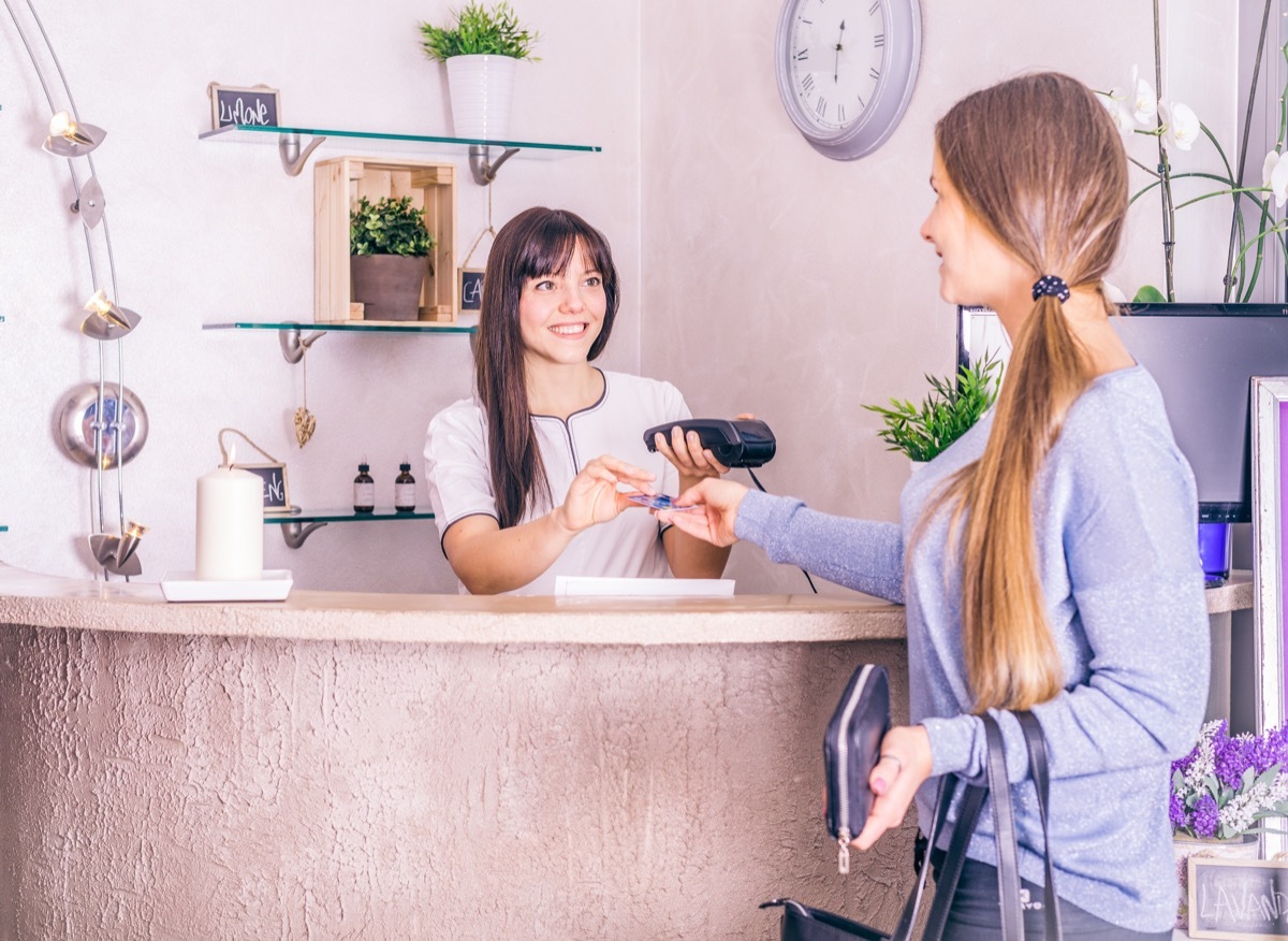 Woman paying for services at the salon