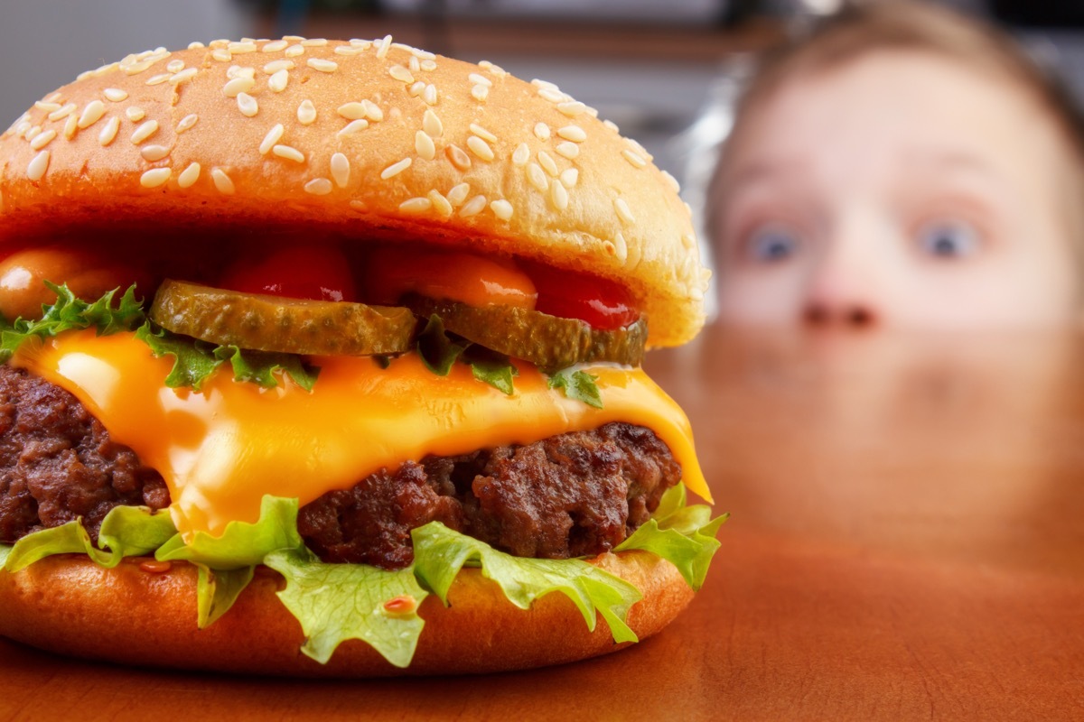child looking at burger