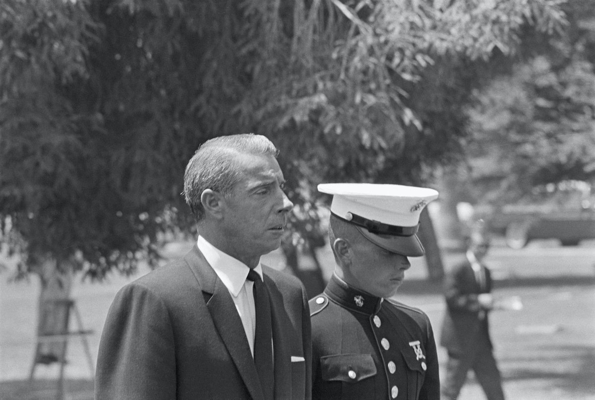 Joe DiMaggio (accompanied by son Joe DiMaggio Jr., in marine uniform) at Marilyn Monroe's funeral.