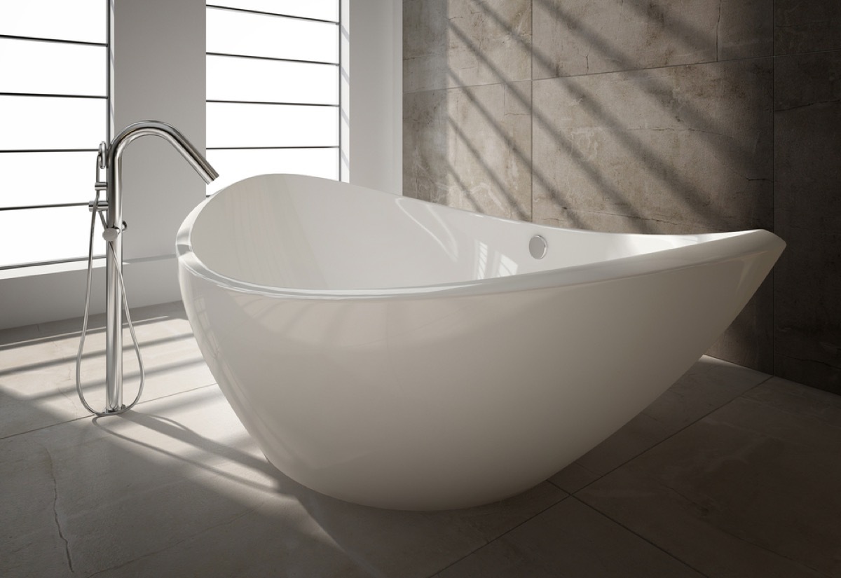 white freestanding tub next to silver faucet