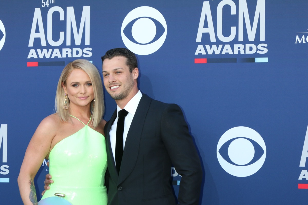 Mirand Lambert wears a green dress and Brendan McLoughlin wears a suit at the 54th Academy of Country Music Awards in 2019