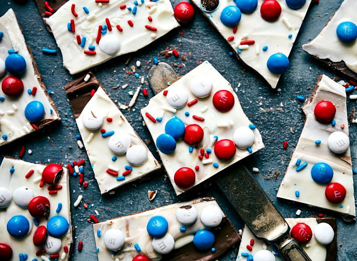 milk and white chocolate bark with red white and blue m&ms and sprinkles