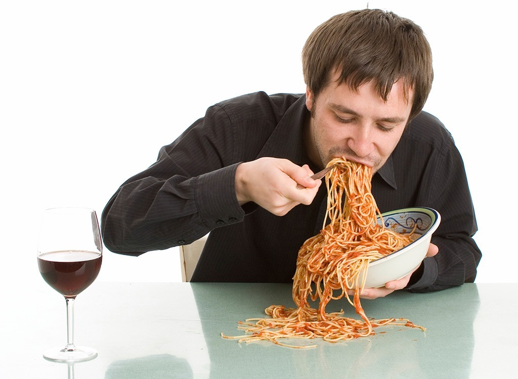 man eating large bowl of pasta - best cheat meal on cheat day