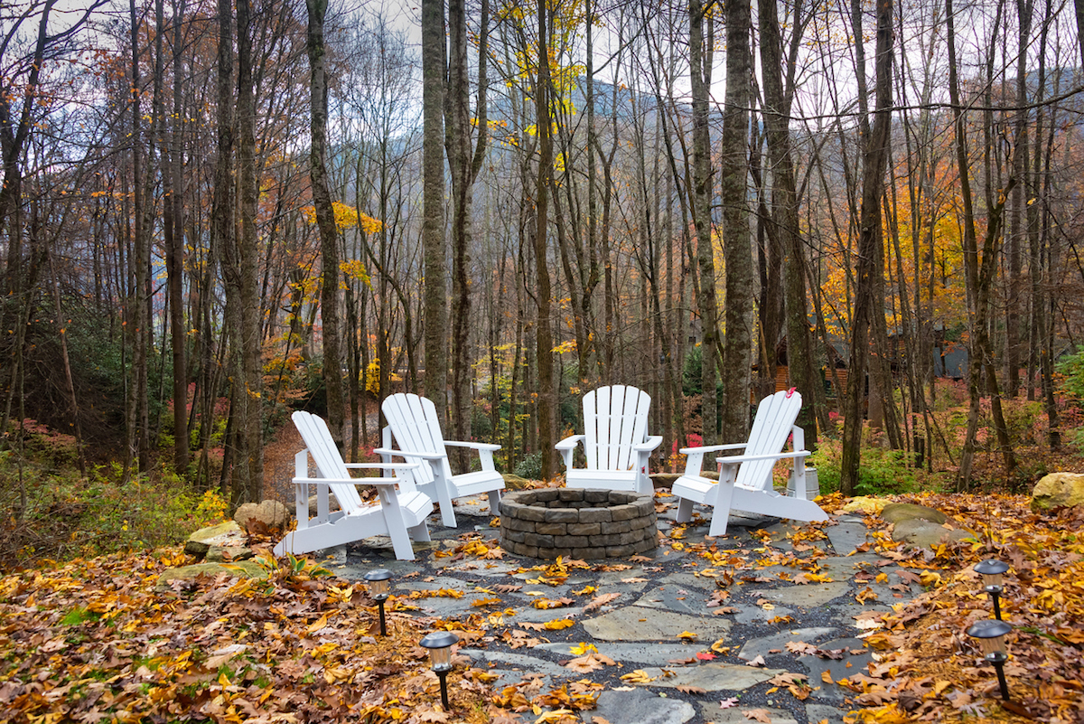 Stone firepit with adirondack chairs surrounding it in the North Carolina mountains