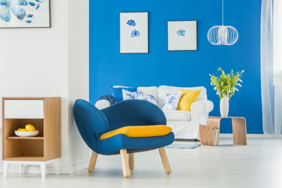 modern home with blue wall and blue chairs