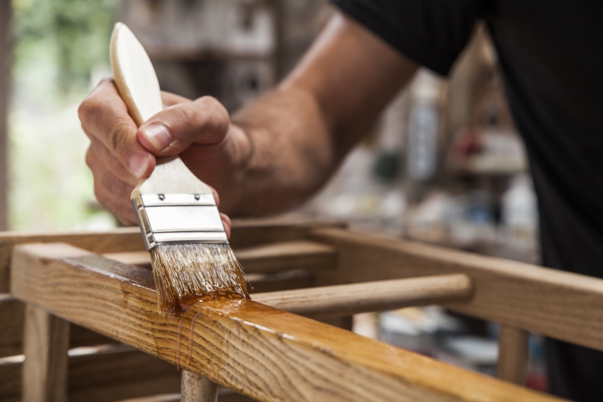 man painting chair