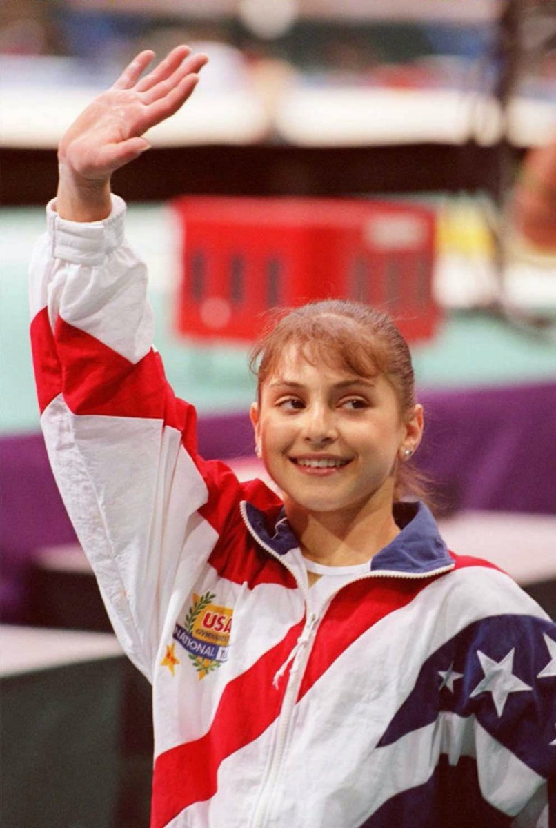 Dominique Moceanu waving to fans at the 1996 Olympics