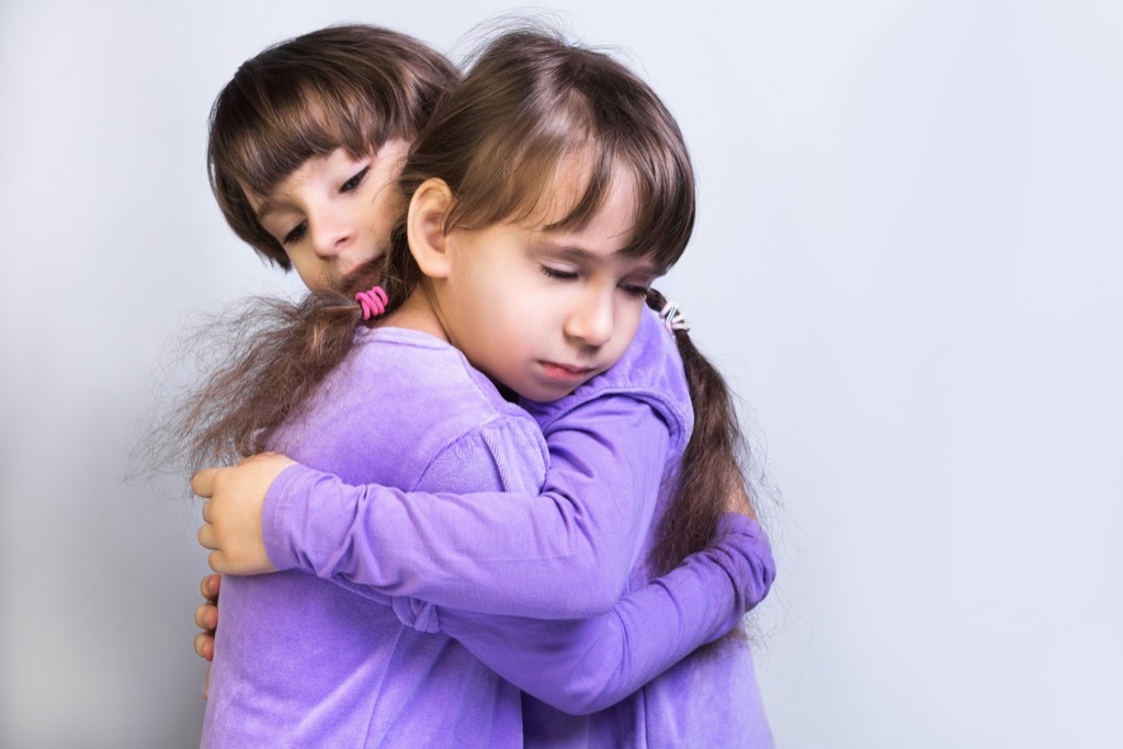 two little girls hug each other