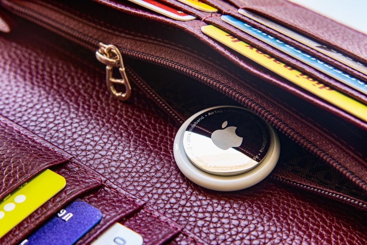 Apple AirTag in a wallet with discount cards and credit cards. New gadgets from Apple