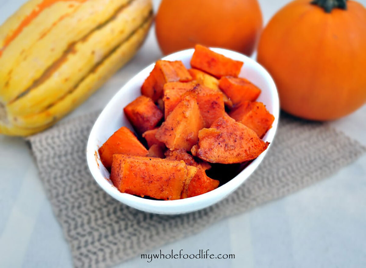 cubed candied yams in white serving bowl