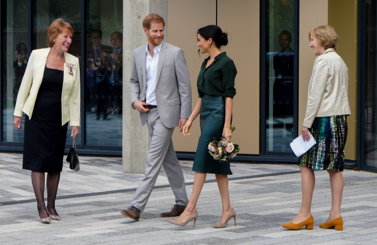 meghan and prince harry walking together, prince harry father