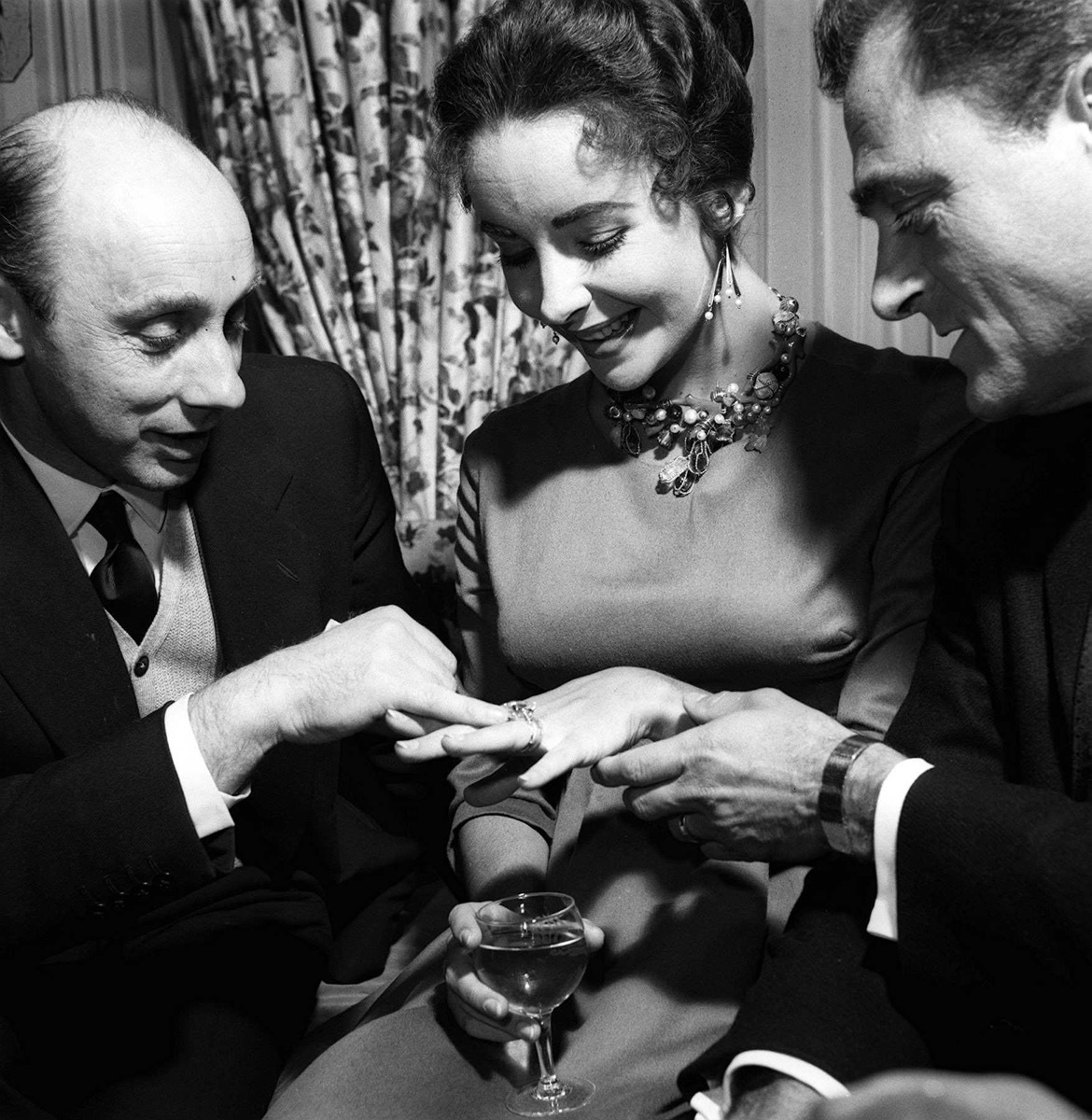 Elizabeth Taylor with Husband Mike Todd showing off diamond ring to Donald Zec April 1957