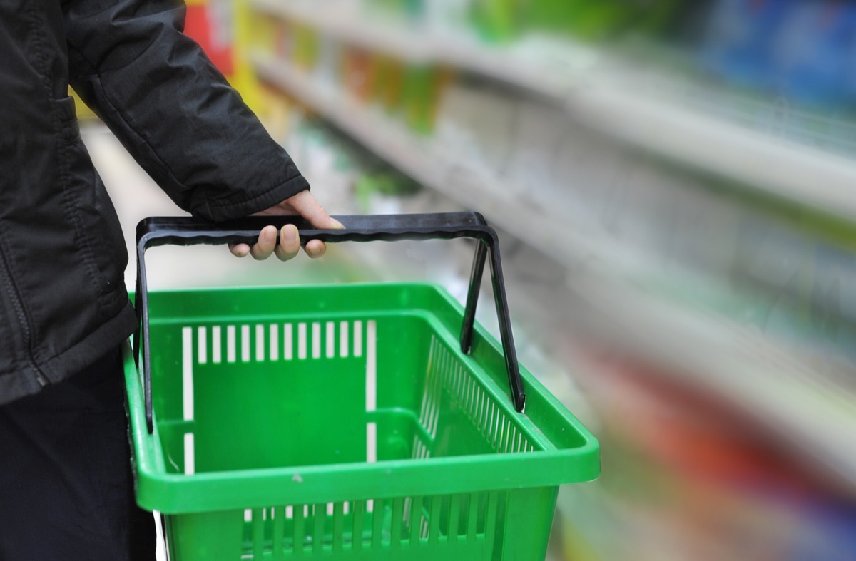 Woman Holding a Shopping Basket at the Store {Smart Shopping Habits}