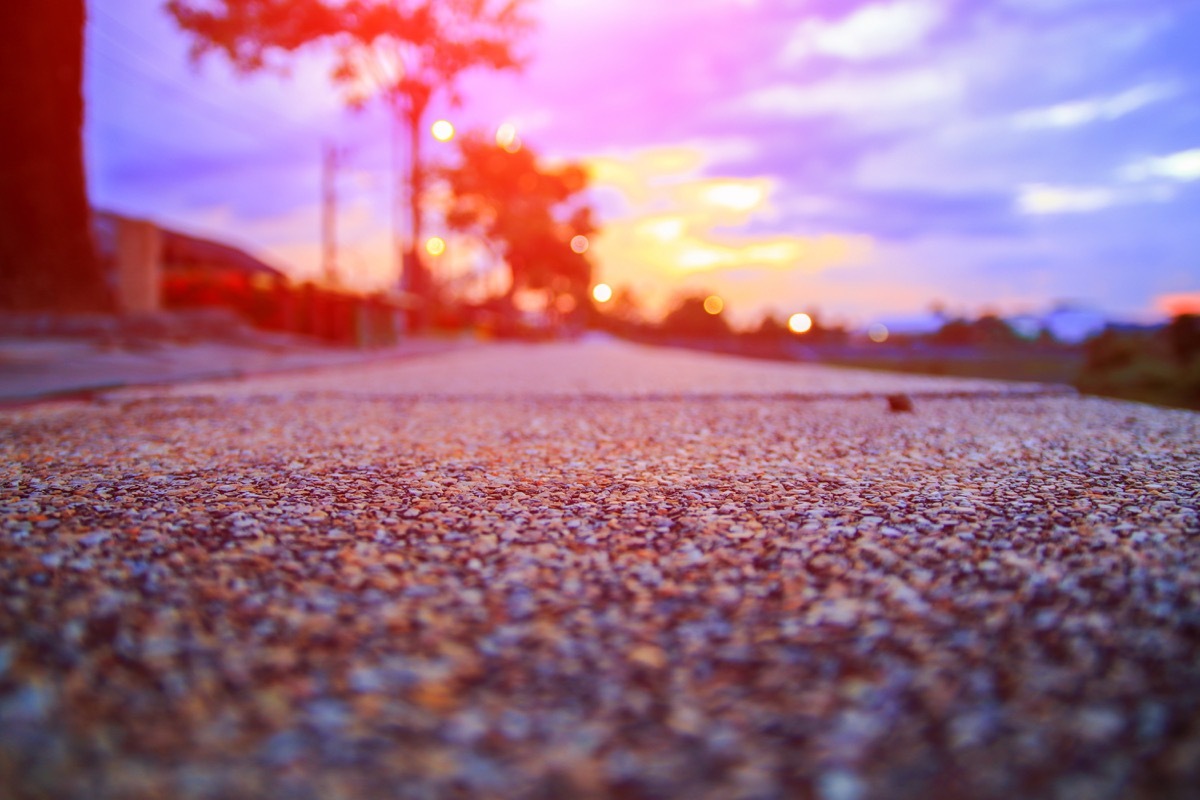 gravel driveway against a sunset