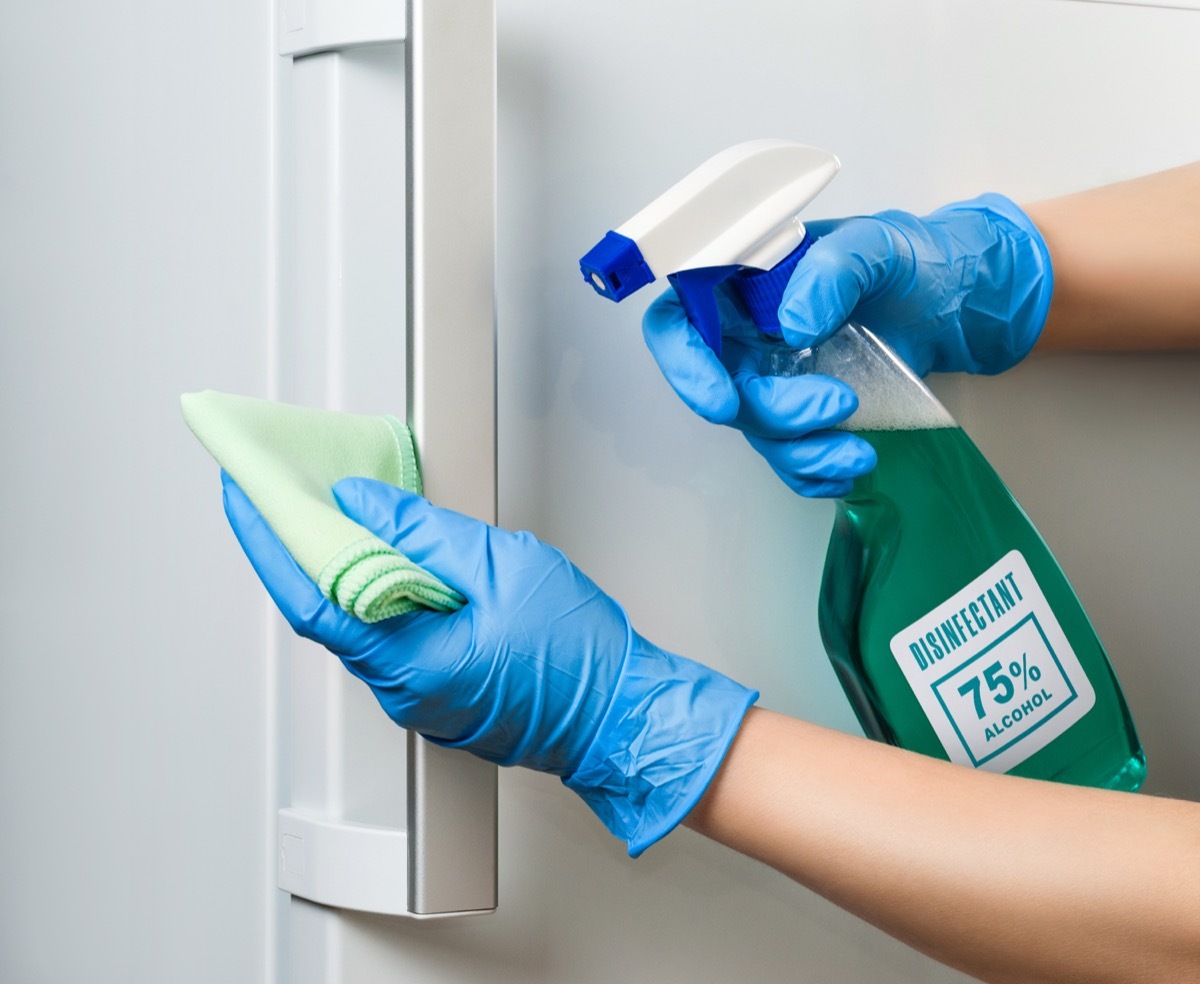 Sanitizing refrigerator handle with disinfectant