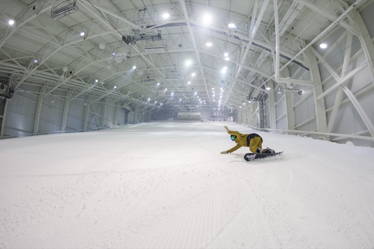 man snowboarding at an indoor ski resort in new jersey