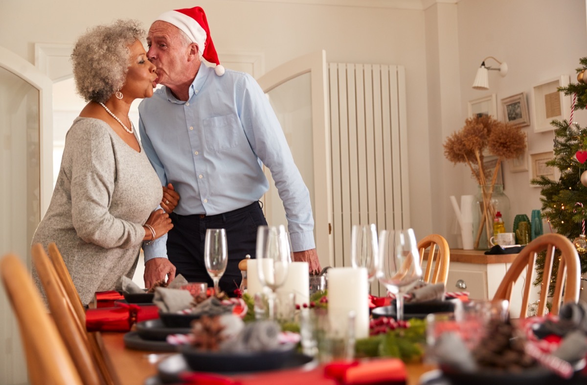 old couple setting up christmas dinner