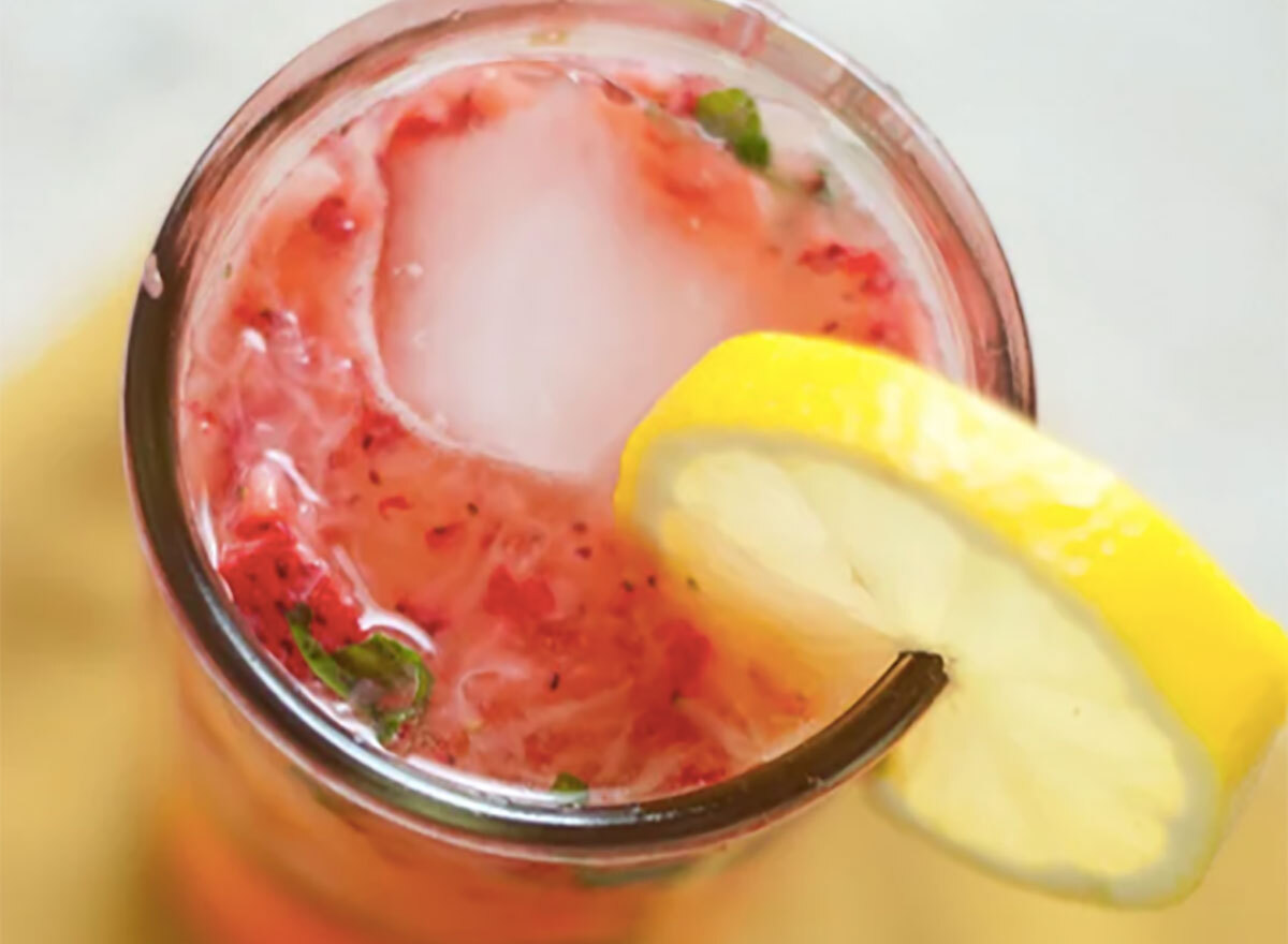 strawberry smash cocktail with lemon wedge