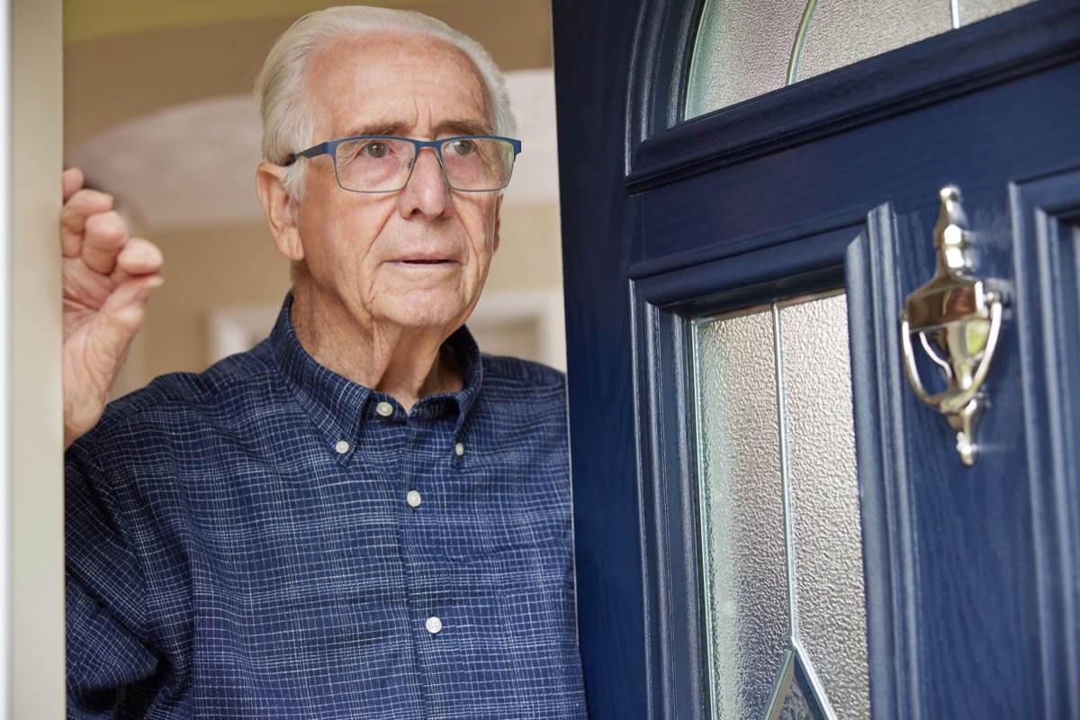 older man opening door