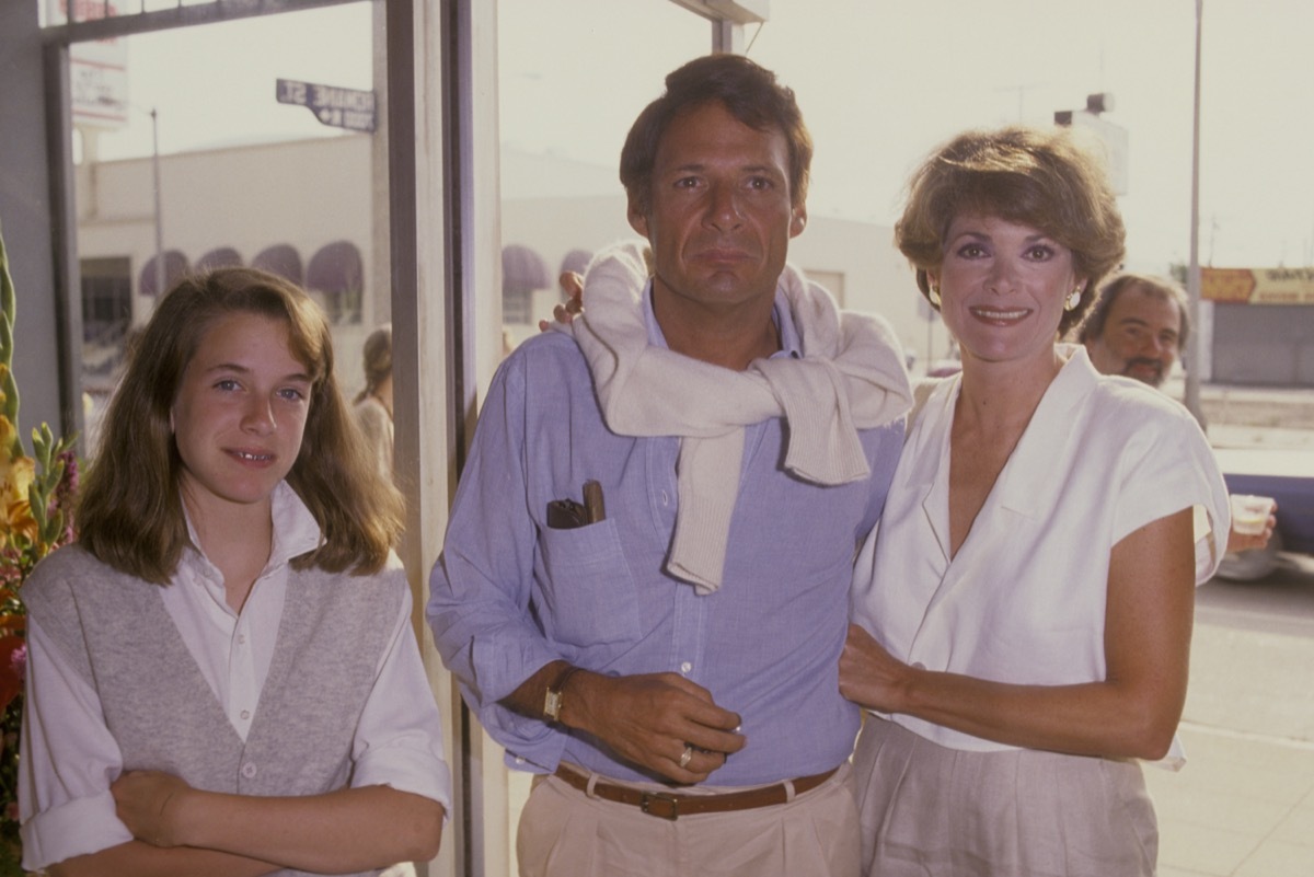 jessica walter with her husband and daughter wearing preppy 80s clothing posing outdoors