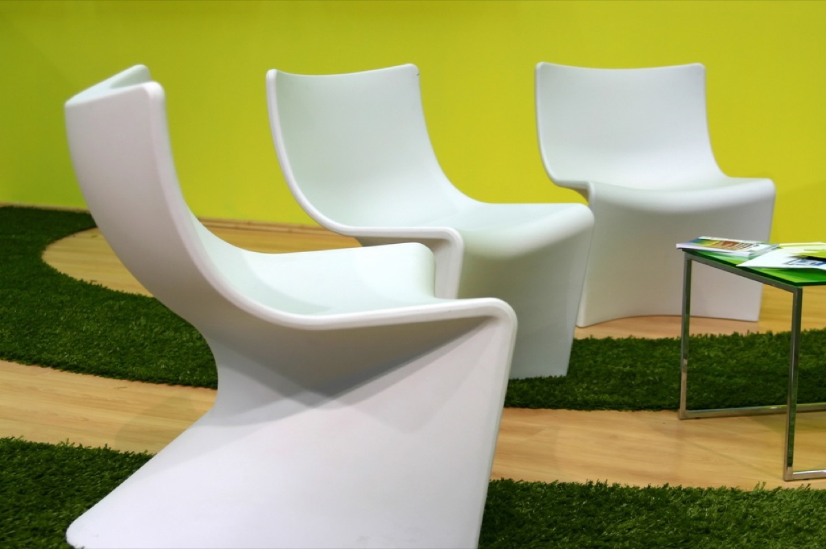 set of three futuristic whote chairs in yellow living room