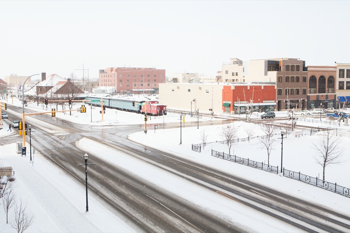 empty street and buildings in downtown Fargo, North Dakota during a snow storm