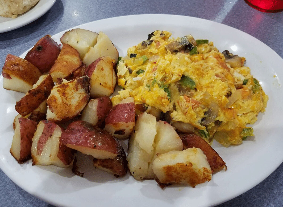 scrambled eggs and home fries on a white plate from southern charm cafe