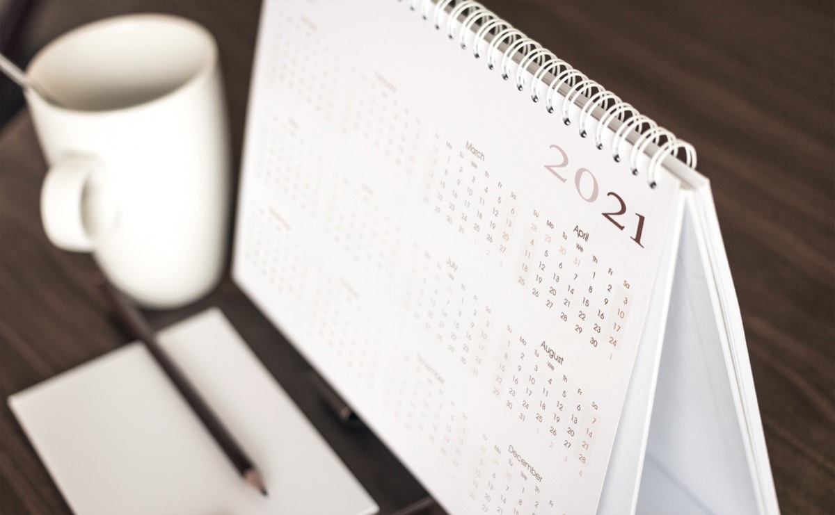 Calendar 2021 schedule with blank note for to do list on wooden desk