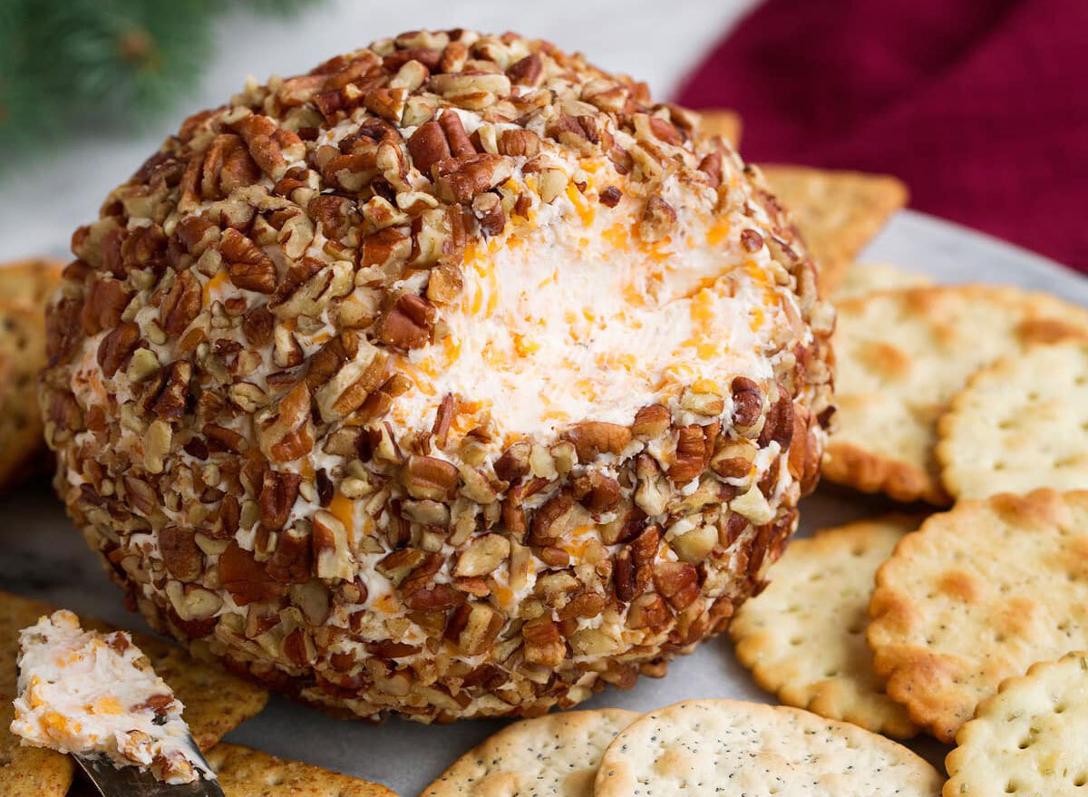 cheese ball appetizer covered in nuts with crackers
