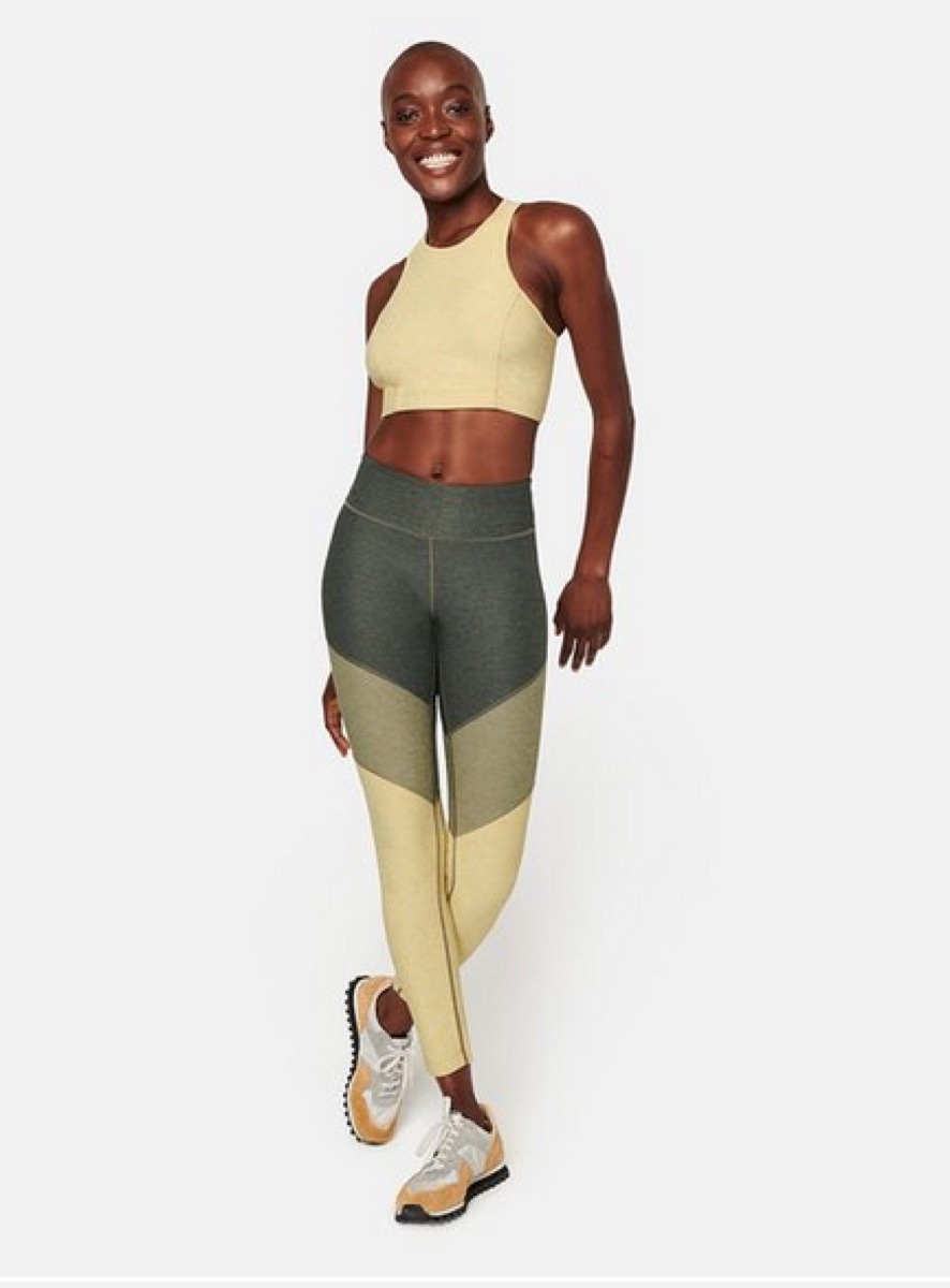 young black woman in leggings and sports bra