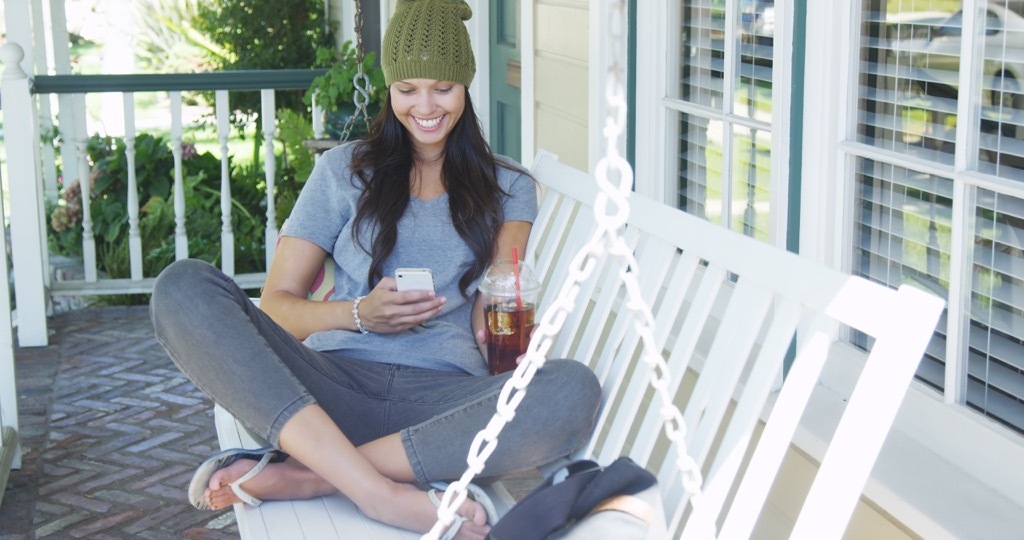 woman porch swing Boosting Your Home's Curb Appeal