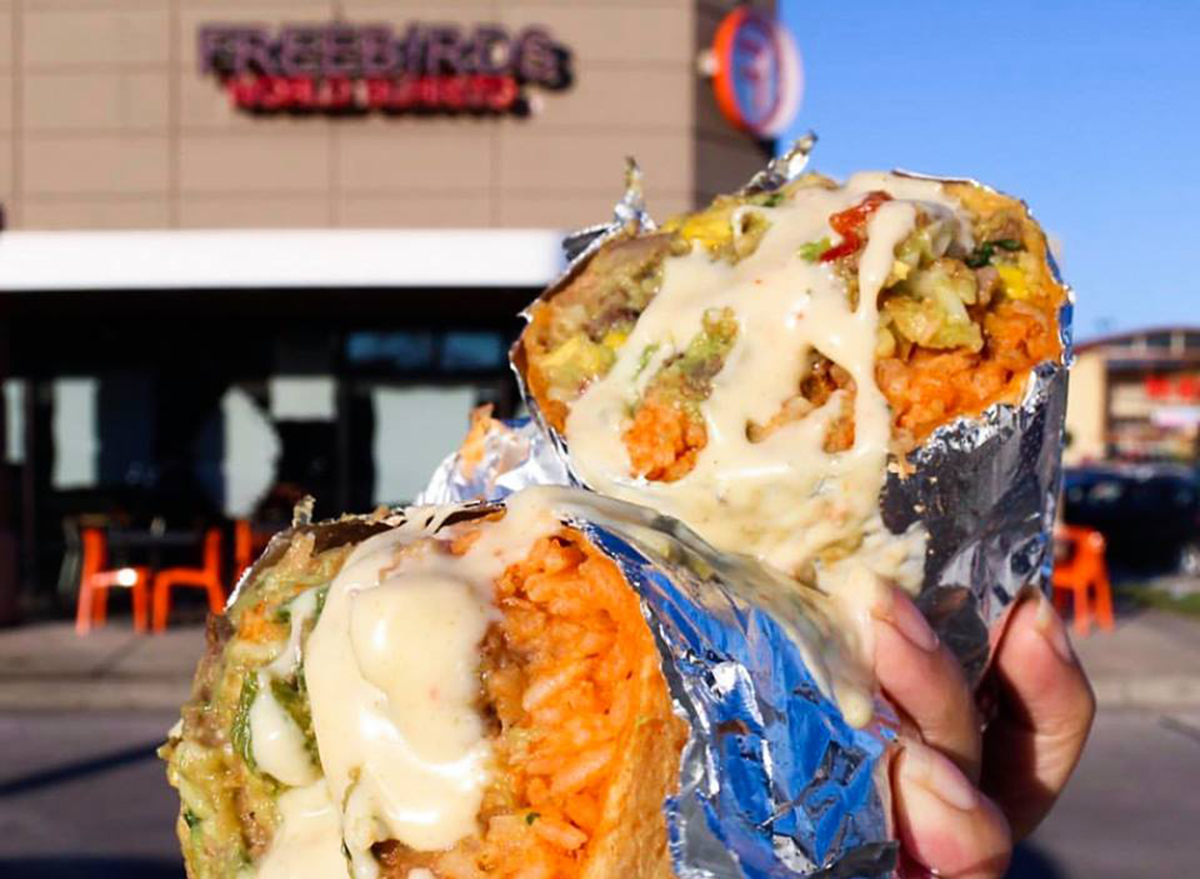 Burrito-split-in-half-in-foil-in-front-of-freebirds-restaurant