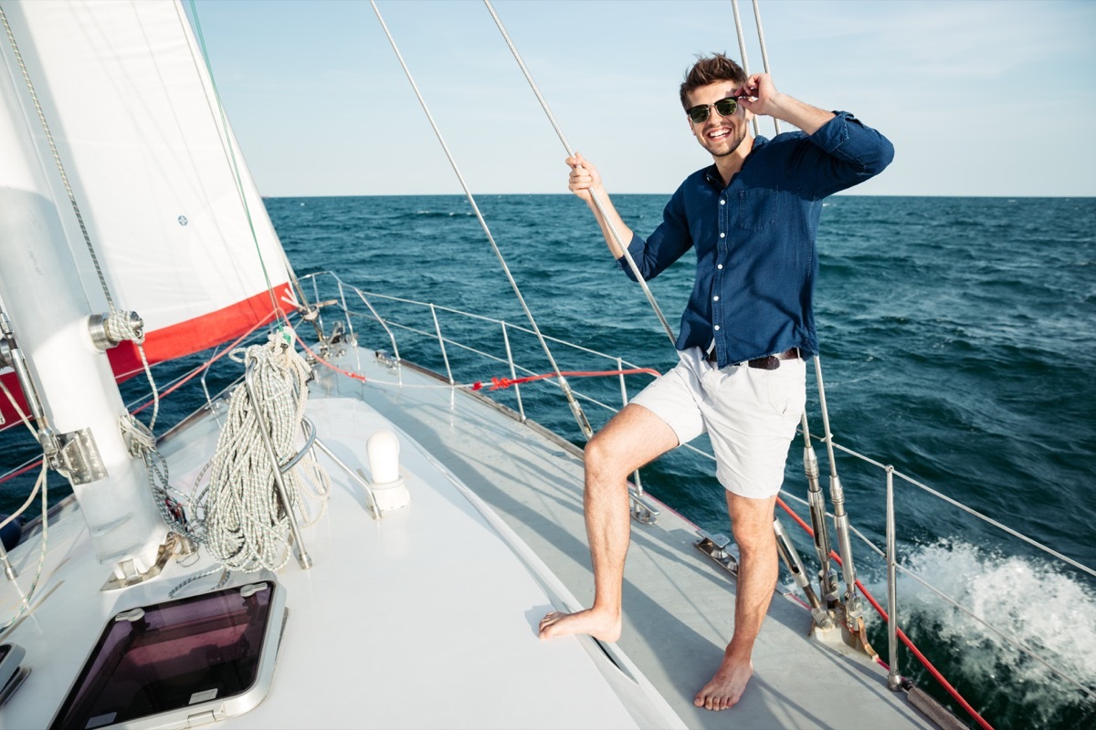 man wearing shorts on a sailboat