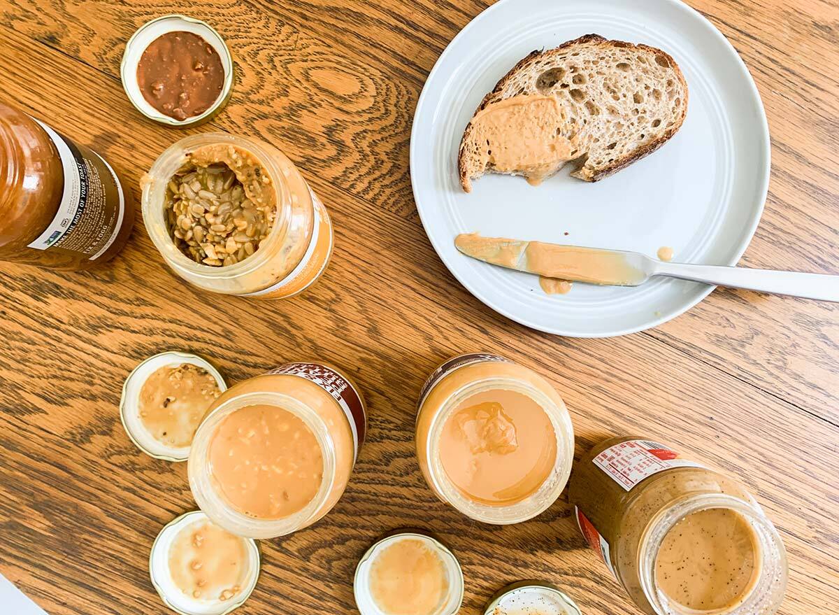 spreading different types of peanut butter on toast