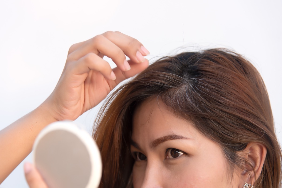 girl finding an early gray hair, hair health signs