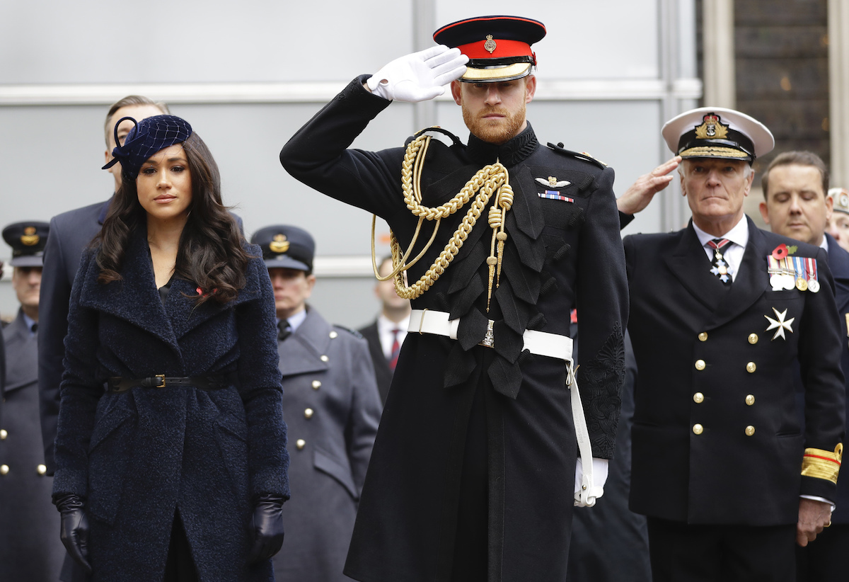 Britain's Prince Harry, Duke of Sussex and his wife Meghan, Duchess of Sussex pay their respects after laying a Cross of Remembrance in front of wooden crosses from the Graves of Unknown British Soldiers from the First and Second World Wars, during their visit to the Field of Remembrance at Westminster Abbey in central London on November 7, 2019