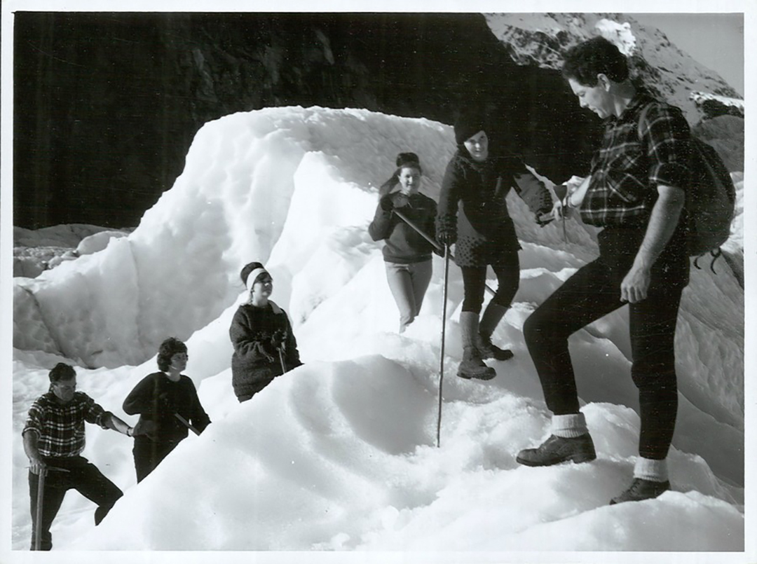 a group of travelers climb a glacier
