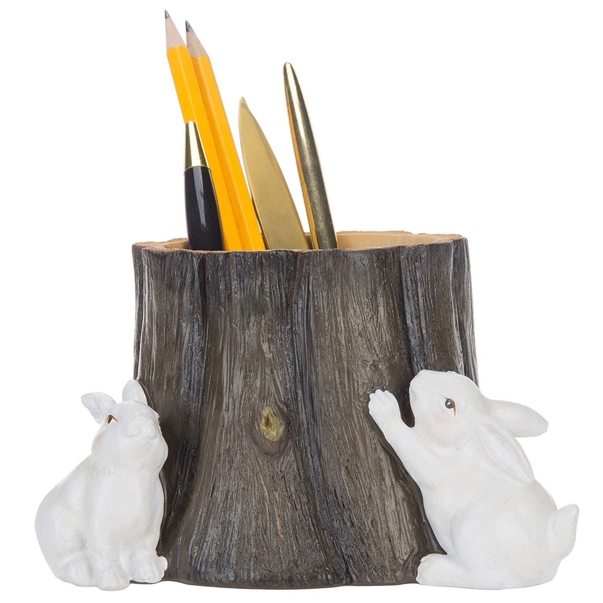 fake tree stump pen holder with white bunnies next to it and pencils inside
