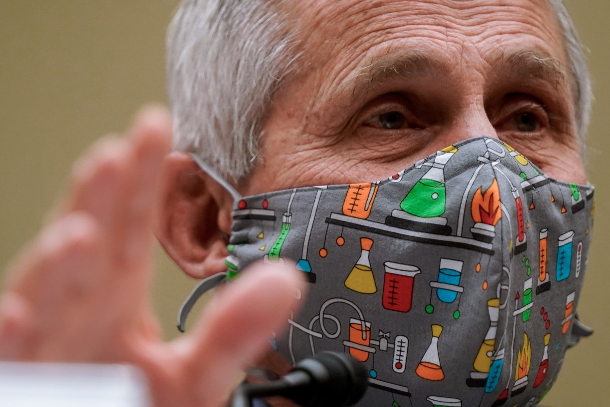 Fauci, wearing a science-themed face mask, speaks