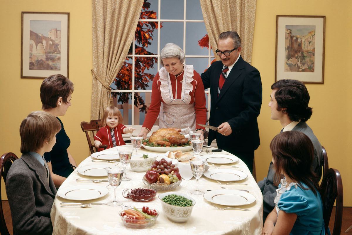 1970s THREE GENERATION FAMILY HAVING THANKSGIVING DINNER